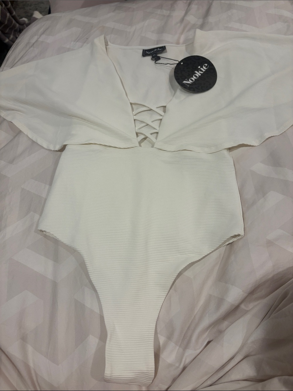 Nookie  Cream Ribbed One-Piece with Ruffle and Lace-Up Front